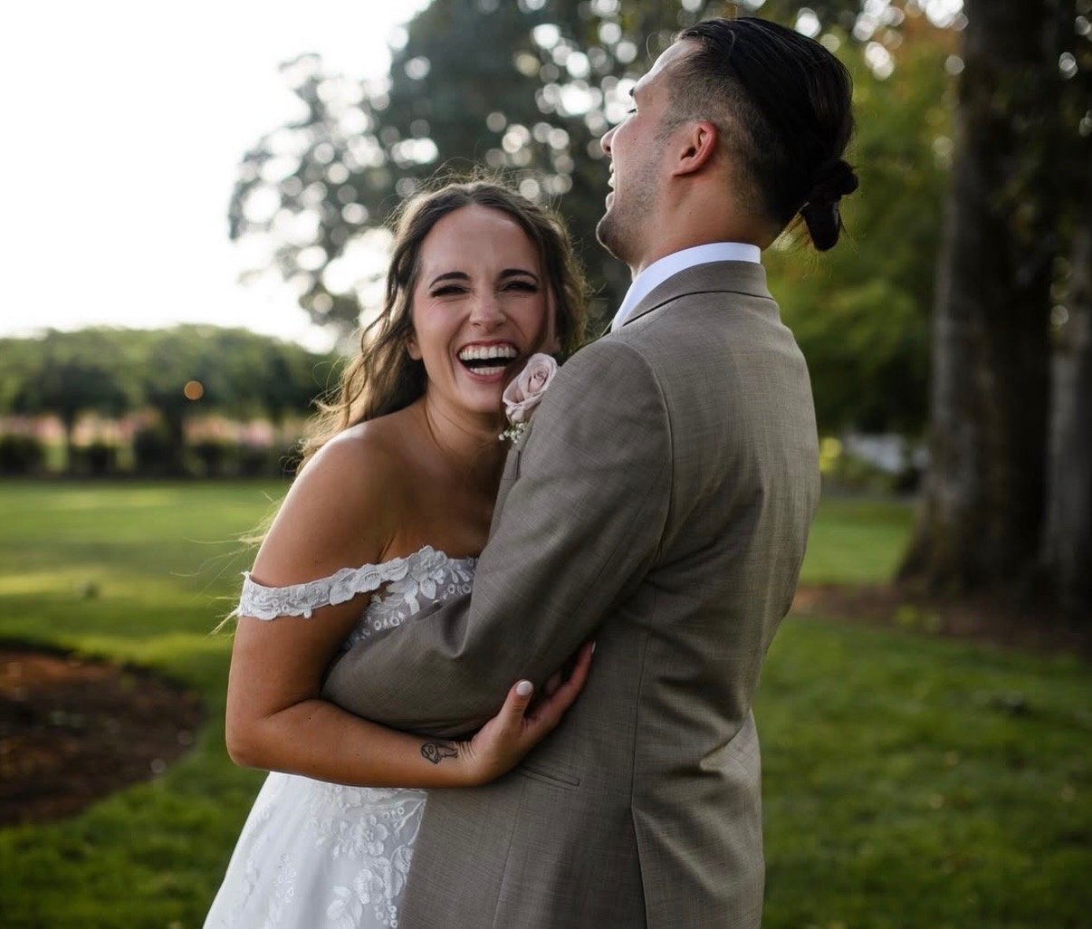 Laughing bride and groom — bridal makeup by Sia Mia