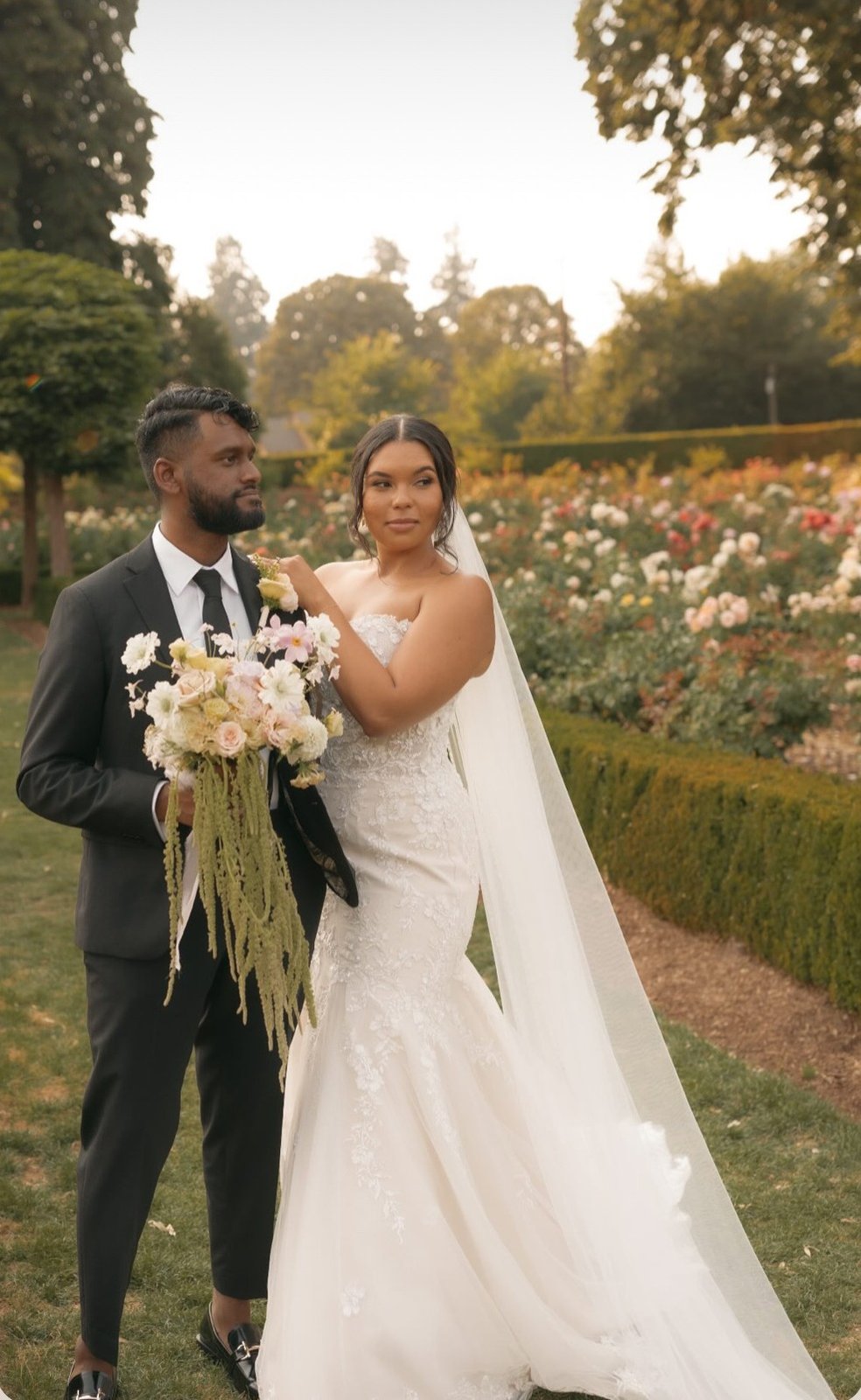 Bride and groom in the rose garden — makeup by Sia Mia