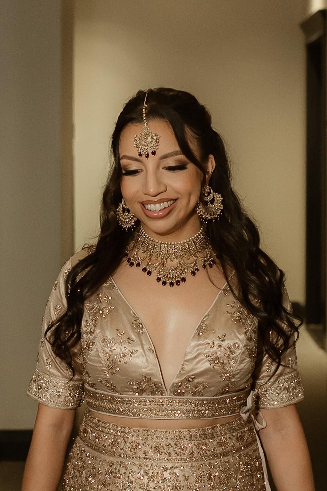 Bride in gold lehenga — traditional bridal makeup and hair by Sia Mia