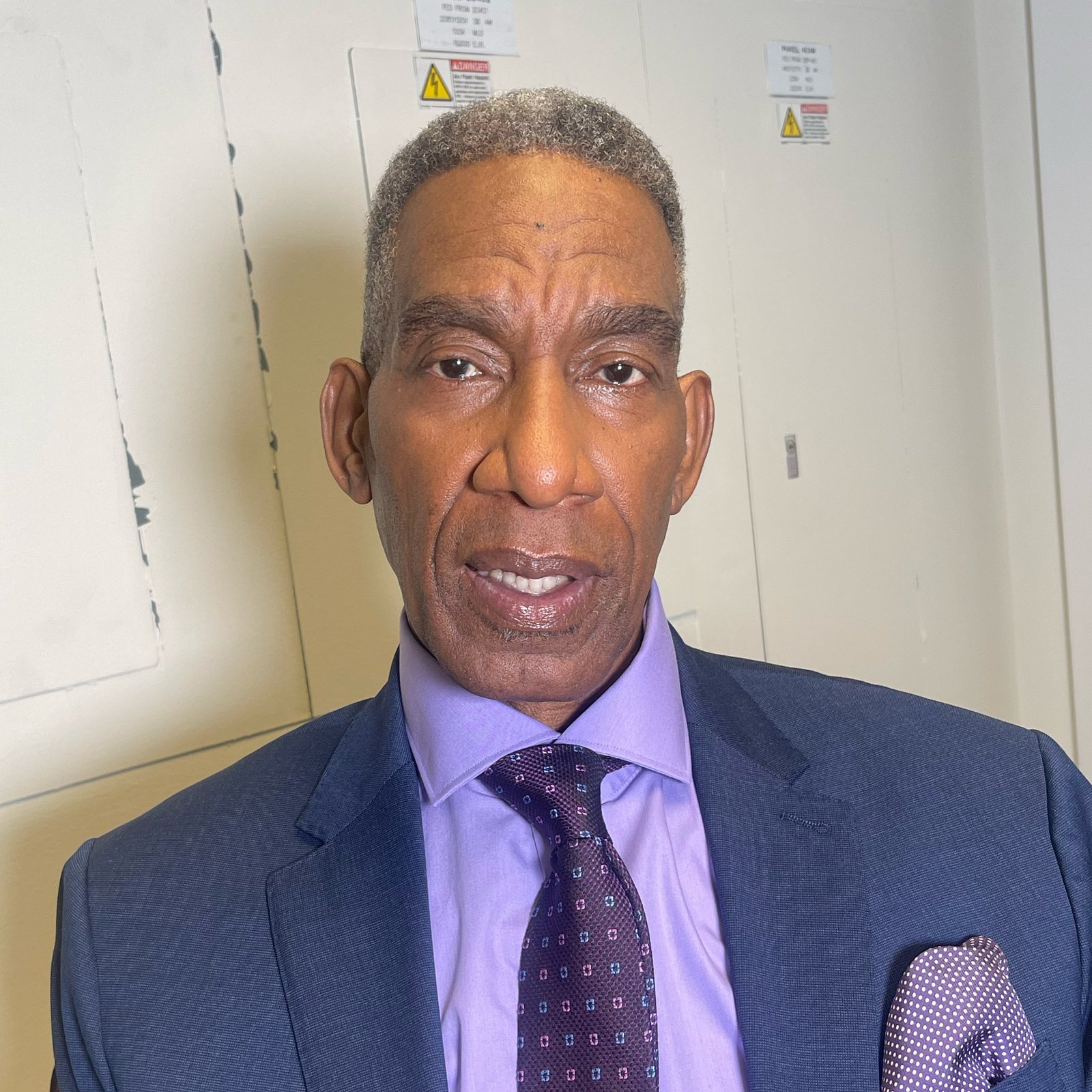 Camera-ready grooming for a client in a suit — makeup by Sia Mia